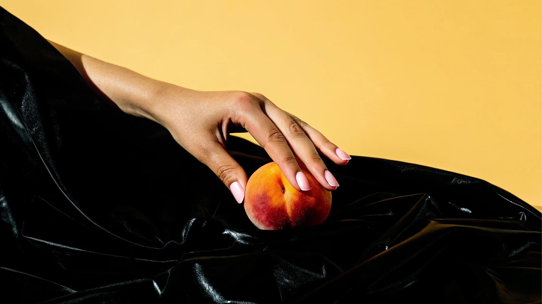 Background image of a hand holding a peach